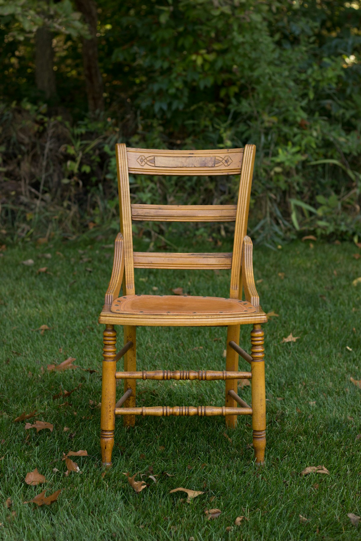 Antique-style wooden chair with turned legs and a carved crest rail
