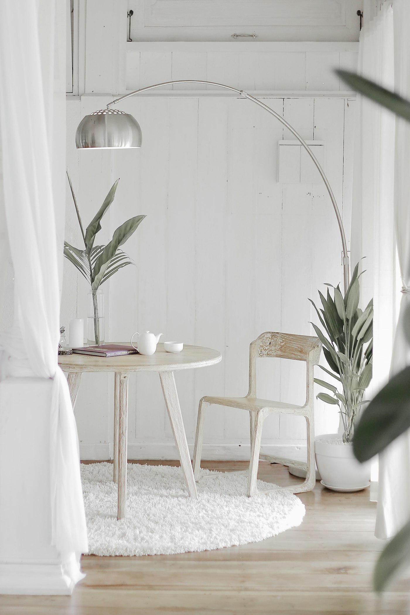 Room with painted vertical board panelling and a slim timber table